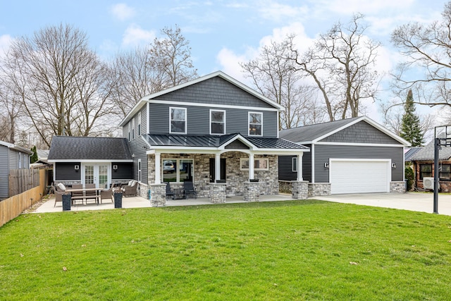 back of property featuring an outdoor living space, fence, stone siding, and a lawn