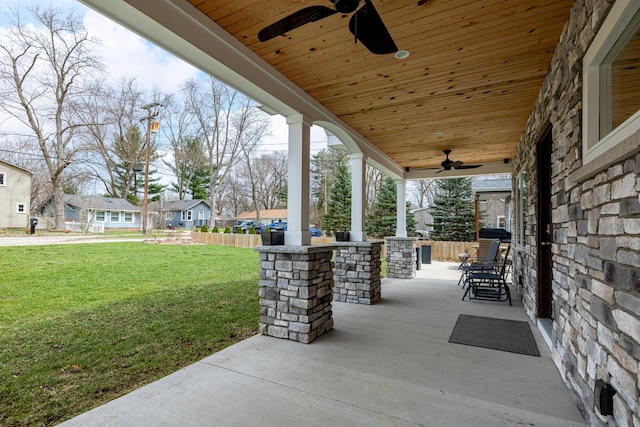 view of patio / terrace featuring a porch, ceiling fan, and a residential view
