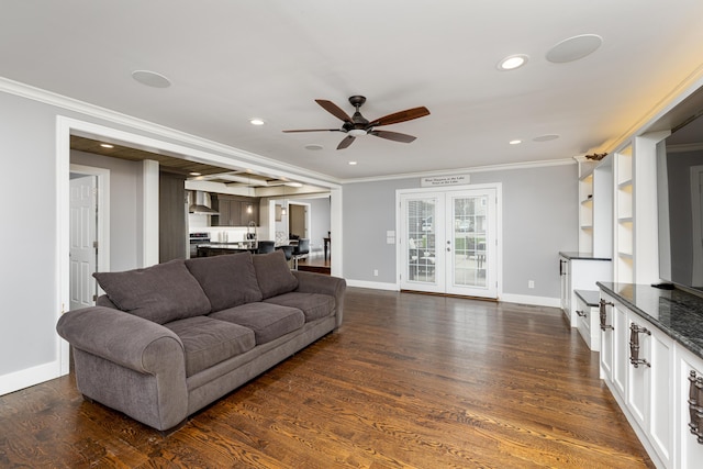 living room featuring ornamental molding, baseboards, a ceiling fan, and dark wood-style floors