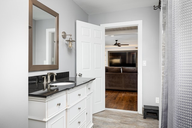 ensuite bathroom with wood finished floors, vanity, ensuite bathroom, and a ceiling fan