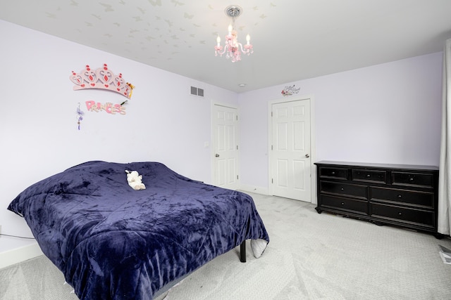 carpeted bedroom featuring a notable chandelier, visible vents, and baseboards