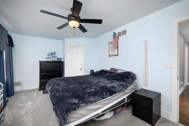 bedroom featuring visible vents, baseboards, a ceiling fan, and carpet flooring