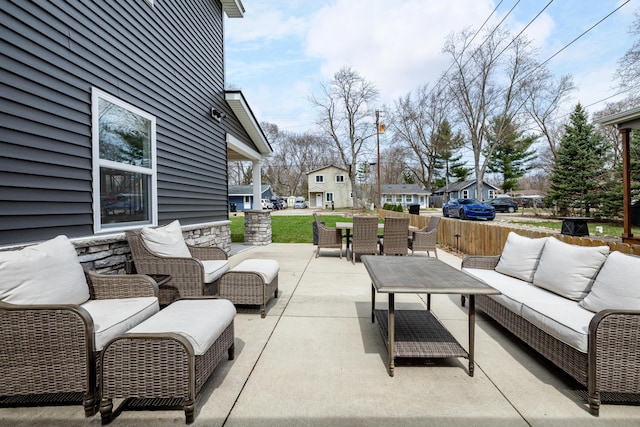 view of patio with outdoor dining space, a residential view, and an outdoor hangout area