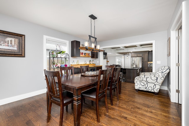 dining area featuring beamed ceiling, baseboards, and dark wood-style floors