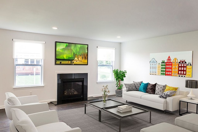499 Cannonade Loop, Howell, MI 48843 - living area with recessed lighting, dark wood-type flooring, a fireplace with flush hearth, and baseboards