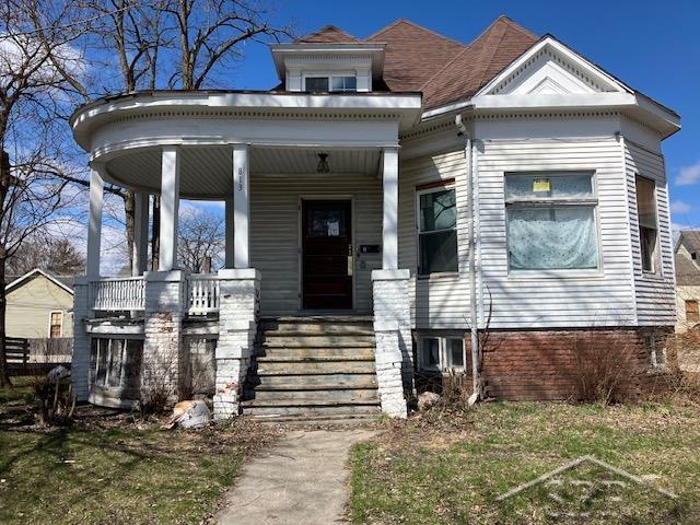 neoclassical home featuring a porch