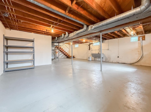 basement featuring a sink and stairway