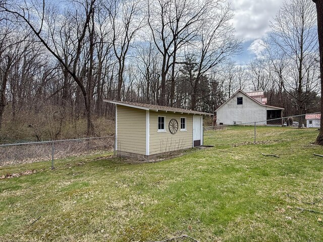 view of yard featuring fence and an outdoor structure