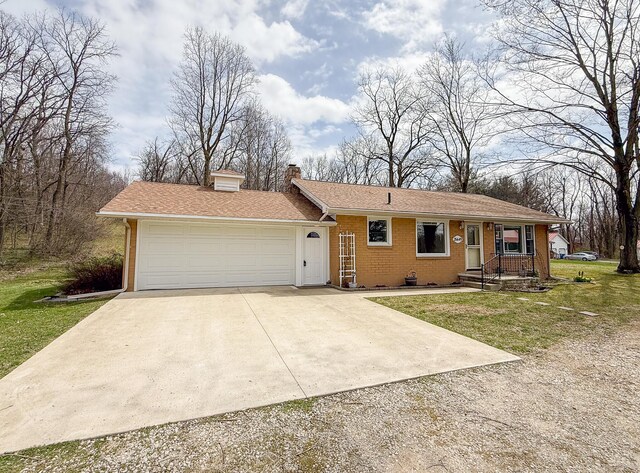 single story home with brick siding, a garage, a chimney, and concrete driveway