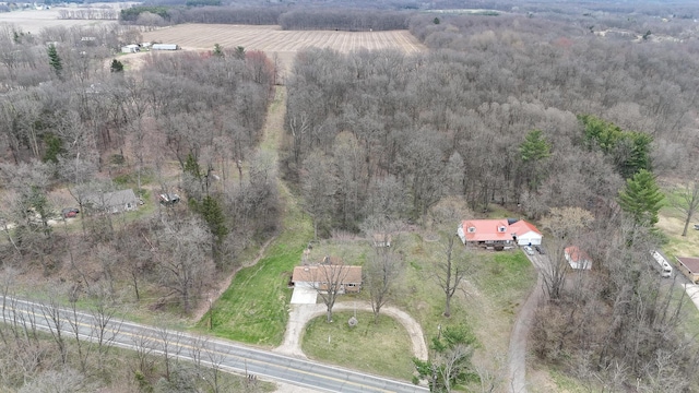 birds eye view of property featuring a rural view and a wooded view