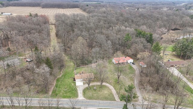 birds eye view of property featuring a forest view and a rural view