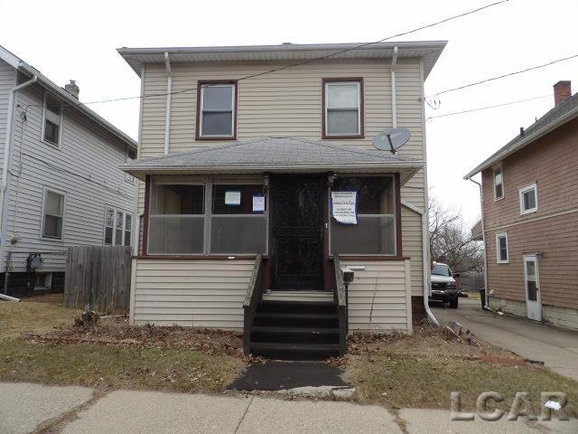 140 Moore St, Jackson, MI 49203 - view of front of home with a sunroom