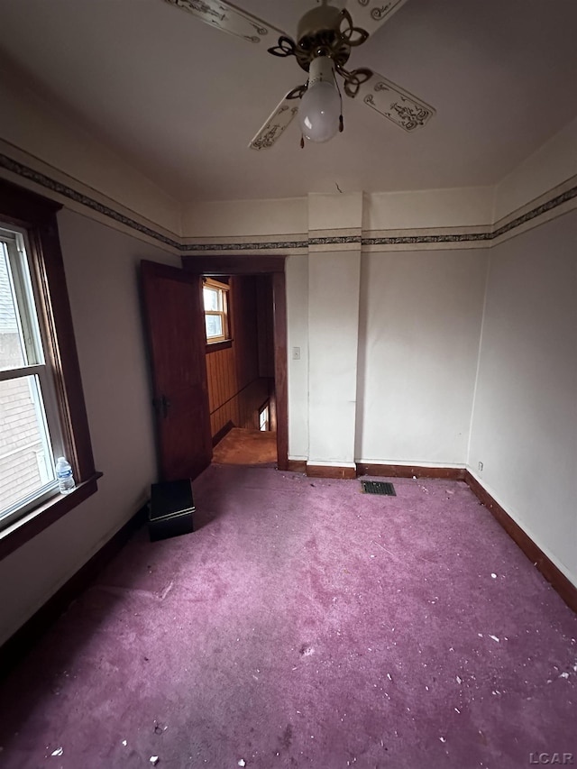 140 Moore St, Jackson, MI 49203 - interior space with carpet, baseboards, and ceiling fan