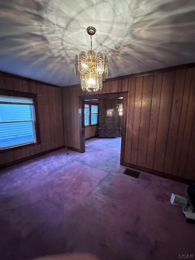 140 Moore St, Jackson, MI 49203 - interior space with a chandelier, wooden walls, baseboards, and visible vents