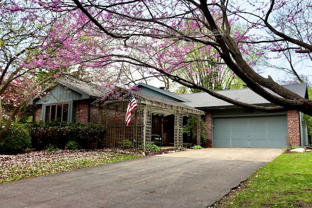 3708 David Ln, Lansing, MI 48911 - view of front of home with brick siding, an attached garage, driveway, and a shingled roof