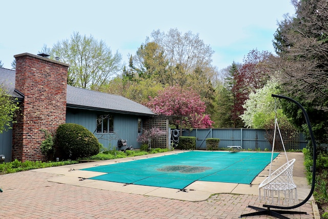 3708 David Ln, Lansing, MI 48911 - view of pool featuring fence, a diving board, and a patio area