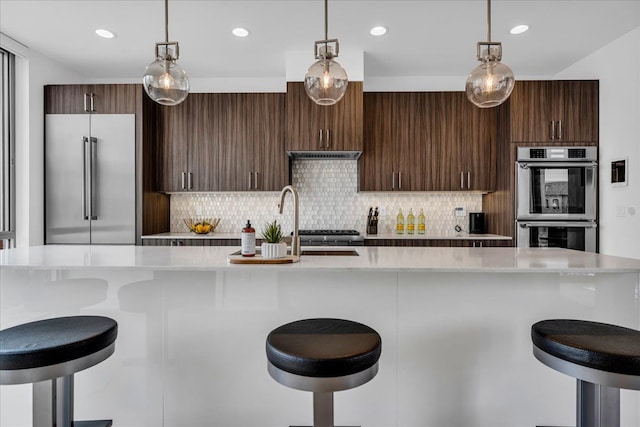 248 Alfred St, Detroit, MI 48201 - kitchen featuring light countertops, pendant lighting, tasteful backsplash, and stainless steel appliances