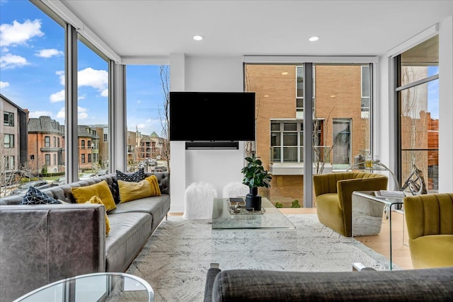 248 Alfred St, Detroit, MI 48201 - living area featuring floor to ceiling windows, a wealth of natural light, and wood finished floors