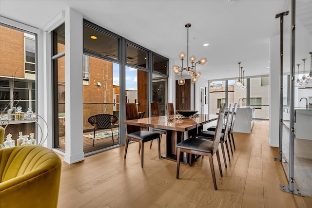 248 Alfred St, Detroit, MI 48201 - dining area featuring recessed lighting, light wood-style flooring, floor to ceiling windows, and a chandelier
