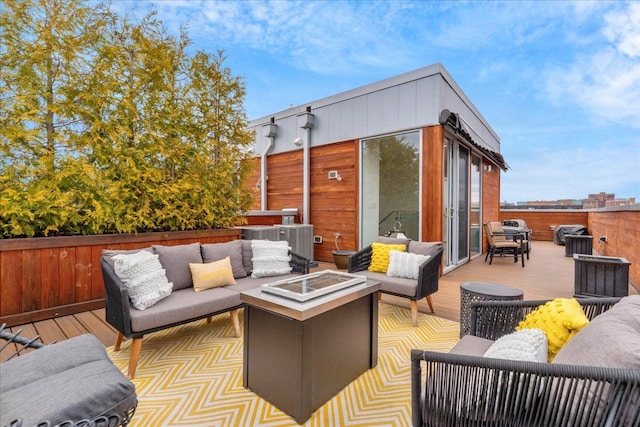248 Alfred St, Detroit, MI 48201 - deck featuring fence, an outdoor living space with a fire pit, and central AC