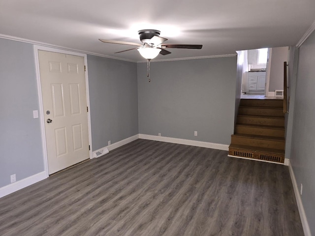 unfurnished living room with a ceiling fan, baseboards, visible vents, crown molding, and dark wood-type flooring
