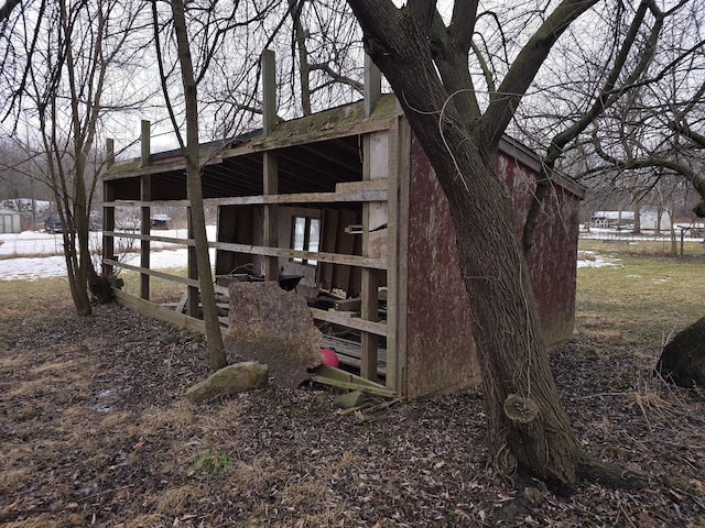 view of side of home featuring an outdoor structure and an exterior structure
