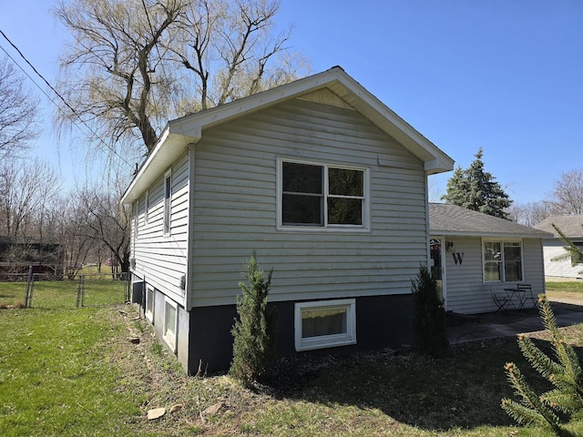 view of side of property featuring a yard and fence