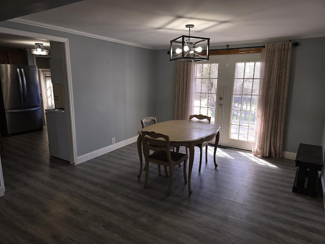 dining area with french doors, dark wood finished floors, crown molding, a notable chandelier, and baseboards