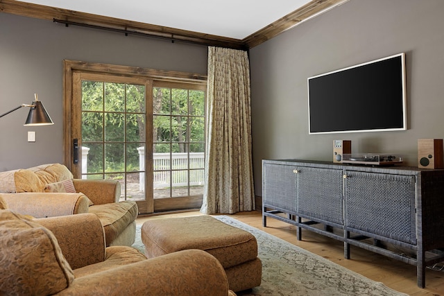 living room with wood finished floors and ornamental molding