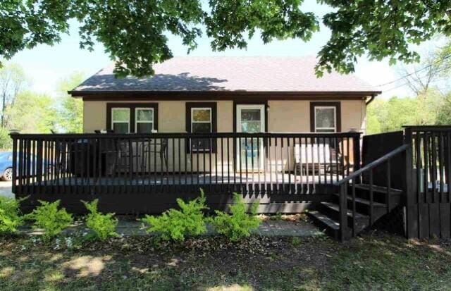 back of house with a deck and stucco siding