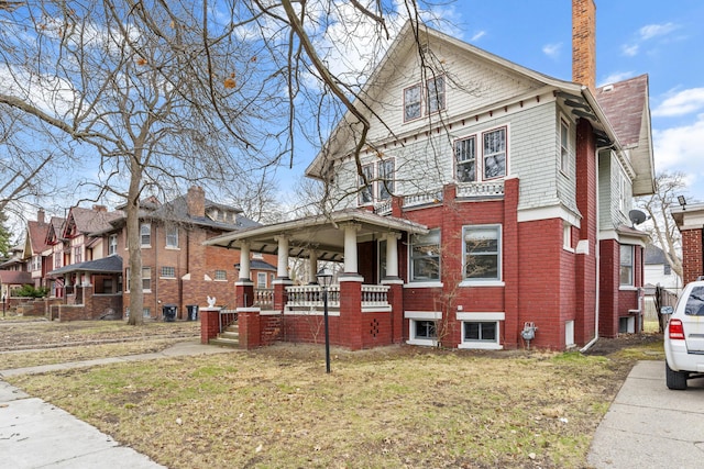 250 Alger St, Detroit, MI 48202 - view of side of property featuring a yard, covered porch, and a chimney