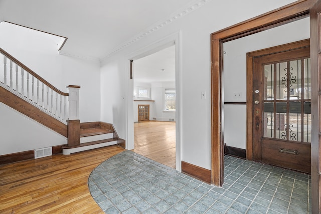 250 Alger St, Detroit, MI 48202 - entrance foyer featuring stairs, visible vents, baseboards, and wood finished floors