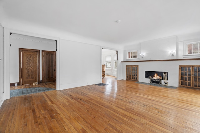 250 Alger St, Detroit, MI 48202 - unfurnished living room with a fireplace with flush hearth and hardwood / wood-style flooring