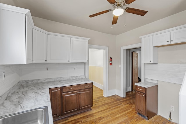 250 Alger St, Detroit, MI 48202 - kitchen with white cabinets, baseboards, a sink, a ceiling fan, and light wood finished floors