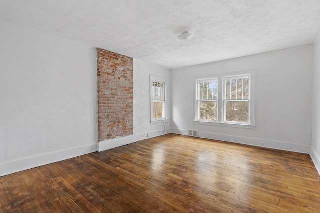 250 Alger St, Detroit, MI 48202 - unfurnished room featuring visible vents, baseboards, hardwood / wood-style floors, and a textured ceiling