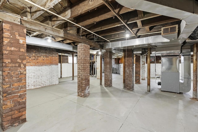 250 Alger St, Detroit, MI 48202 - unfinished below grade area with brick wall, visible vents, and heating unit