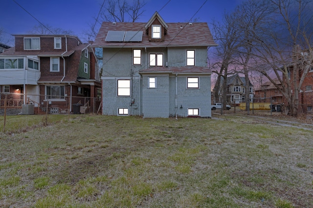 250 Alger St, Detroit, MI 48202 - rear view of property featuring a yard, cooling unit, fence, and roof mounted solar panels