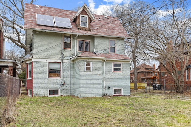 250 Alger St, Detroit, MI 48202 - rear view of property featuring a yard, a fenced backyard, and roof mounted solar panels