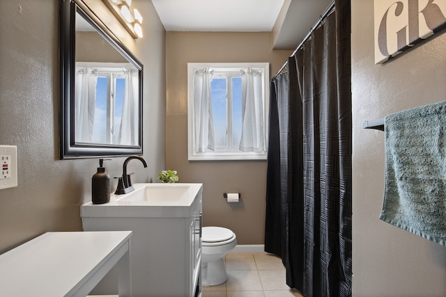 full bath with toilet, plenty of natural light, tile patterned flooring, and vanity