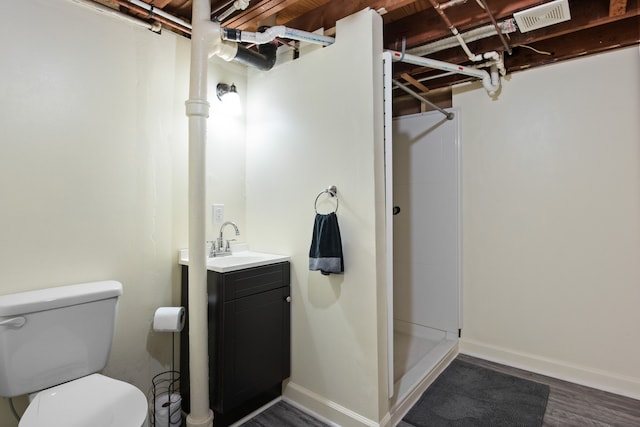 full bath featuring vanity, a stall shower, toilet, visible vents, and wood finished floors