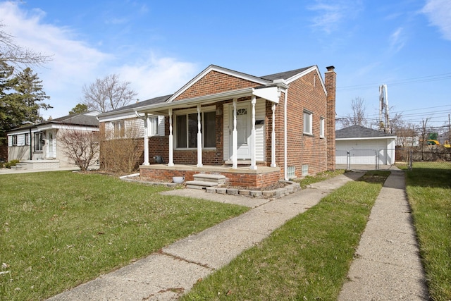 bungalow with a chimney, a front lawn, a porch, brick siding, and fence