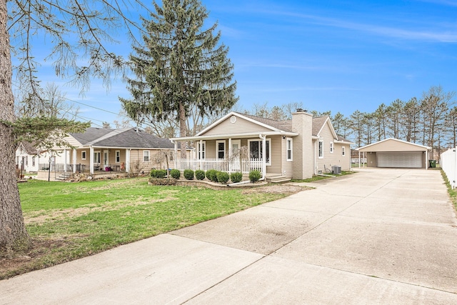 view of front of home with an outdoor structure, a porch, a front lawn, a chimney, and a garage