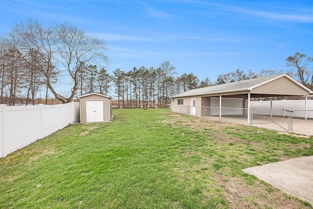 view of yard with an outbuilding, a fenced backyard, a carport, and a storage unit