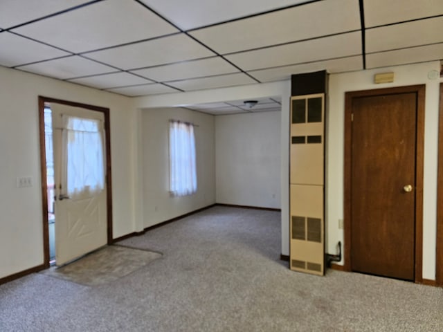 foyer with a paneled ceiling, baseboards, and carpet floors
