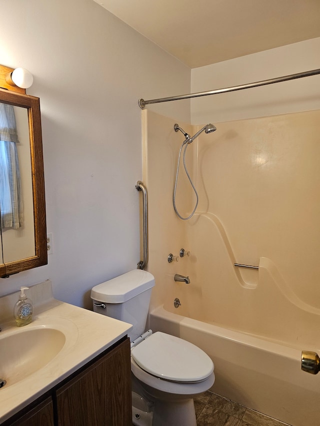 full bathroom with toilet, vanity, and washtub / shower combination