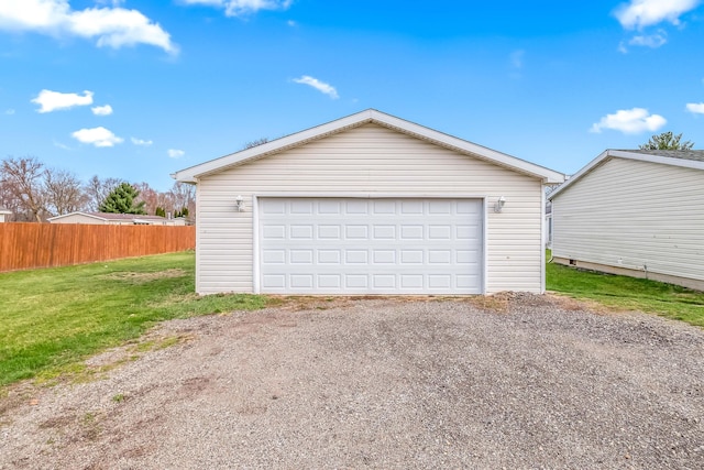 detached garage featuring fence