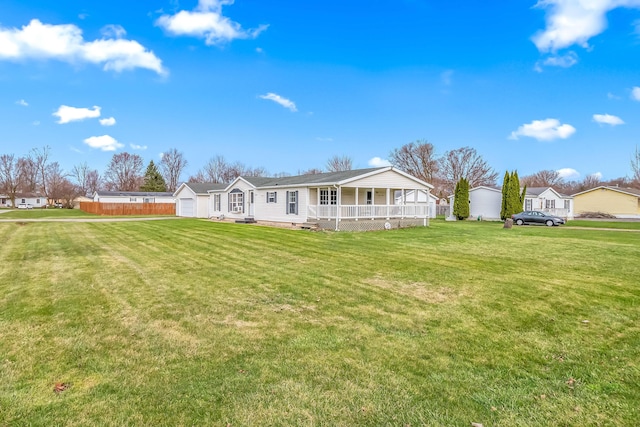 rear view of property with a yard and a porch