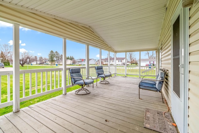 wooden deck featuring a yard and a residential view
