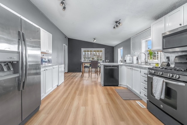 kitchen featuring white cabinets, light wood-style flooring, and appliances with stainless steel finishes