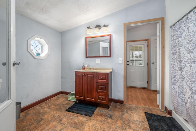 full bath with baseboards, plenty of natural light, and vanity